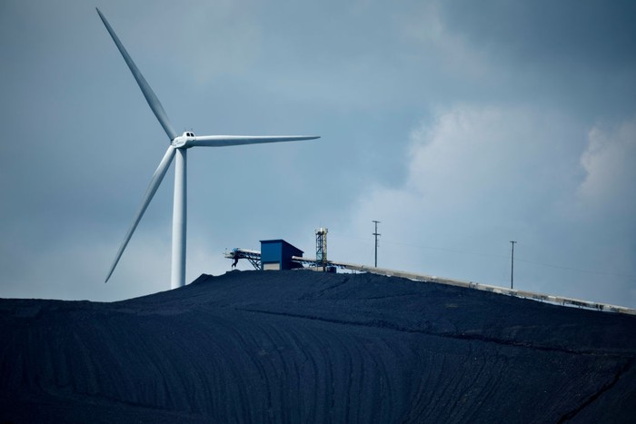 OAKLAND, MARYLAND - AUGUST 23: In an aerial view, turbines from the Roth Rock wind farm spin on the spine of Backbone Mountain next to the Mettiki Coal processing plant on August 23, 2022 in Oakland, Maryland. The 50,000 kilowatt Roth Rock project has 20 Nordex N90/2500 turbines and has been operating since 2011. Once Maryland’s largest coal mine, the Mettiki pulled a total of 55 million short tons from the Upper Freeport seam in Garrett County’s southwestern corner between 1983 and 2006, when the mine was closed. Today, the former mine site still washes, separates and processes coal from nearby mines. (Photo by Chip Somodevilla/Getty Images)