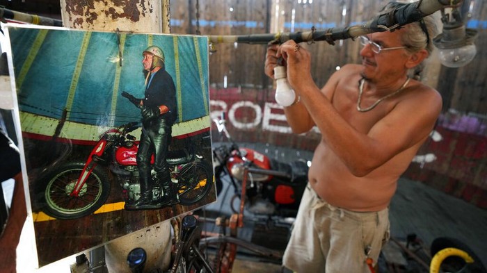 Zoran Milojkovic rides a motorcycle on the 