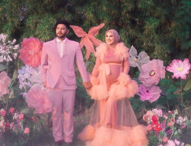 Sementara Ammar Zoni mengenakan setelan jas pink. Kesan dreamy pun semakin kuat dengan backdrop bunga-bunga besar. Foto: dok. Instagram/@_irishbella_