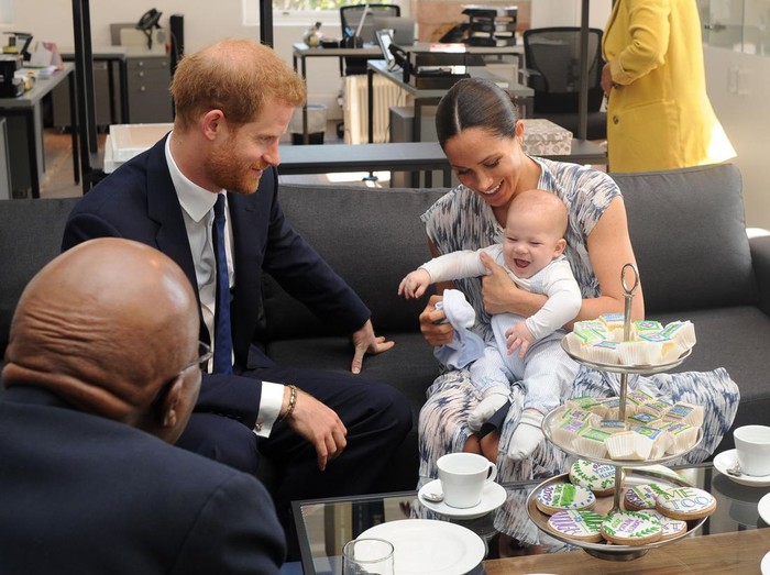 Britains Duke and Duchess of Sussex, Prince Harry and his wife Meghan hold their baby son Archie as they meet with Archbishop Desmond Tutu at the Tutu Legacy Foundation  in Cape Town on September 25, 2019. - The British royal couple are on a 10-day tour of southern Africa -- their first official visit as a family since their son Archie was born in May. (Photo by HENK KRUGER / POOL / AFP)        (Photo credit should read HENK KRUGER/AFP via Getty Images)
