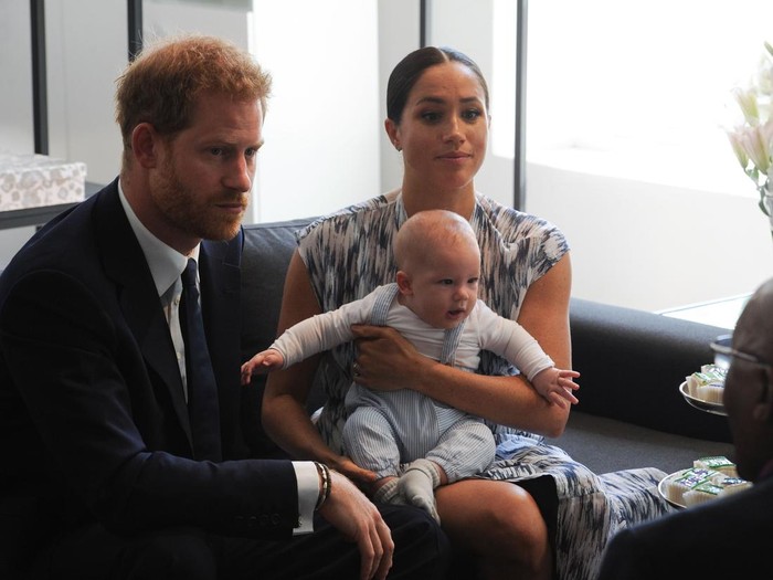 Britains Duke and Duchess of Sussex, Prince Harry and his wife Meghan hold their baby son Archie as they meet with Archbishop Desmond Tutu at the Tutu Legacy Foundation  in Cape Town on September 25, 2019. - The British royal couple are on a 10-day tour of southern Africa -- their first official visit as a family since their son Archie was born in May. (Photo by HENK KRUGER / POOL / AFP)        (Photo credit should read HENK KRUGER/AFP via Getty Images)