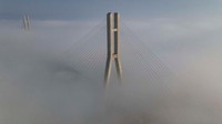 Lalu sebuah jembatan di Yangpu, China, terlihat dibangun di atas awan pada 25 Januari 2021. 