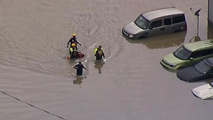Stalled cars sit abandoned on the flooded Interstate 635 Service Road on Monday, Aug. 22, 2022, in Mesquite, Texas. The National Weather Service issued a flash flood warning early Monday morning which was extended until 1 p.m. (Elías Valverde II/The Dallas Morning News via AP)