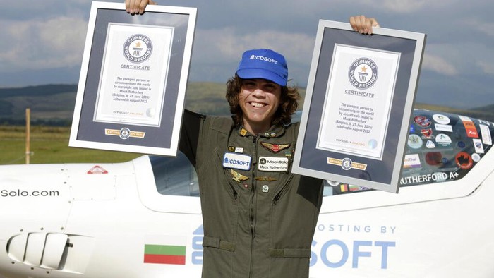 Mack Rutherford, a 17-year-old British-Belgian pilot holds his Guinness award plates after he landed in Sofia-West ariport, Wednesday Aug. 24, 2022. Rutherford has become the youngest person to fly solo around the world in a small aircraft after he landed in Bulgaria, the country where his journey kicked off five months ago. Rutherford landed on an airstrip west of Bulgarian capital Sofia on Wednesday to complete his task and to claim two Guinness World Records. (AP Photo/ Jordan Simeonov)