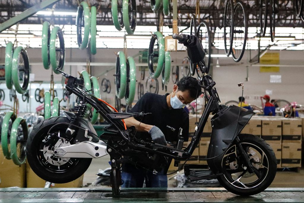 An employee works at the assembly line of an electric motorcycle at the United E-Motor factory in Bogor, near Jakarta, Indonesia, August 25, 2022. REUTERS/Ajeng Dinar Ulfiana