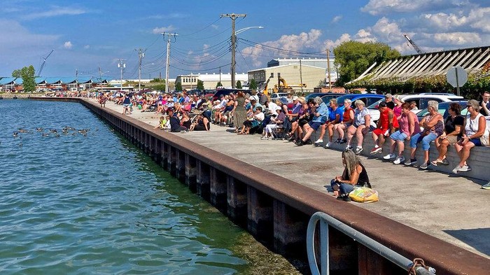 Crowds lined the East Pier at Dobbins Landing during the Parade of Sail on Presque Isle Bay that opened the 2022 Tall Ships Erie festival, Thursday, Aug. 25, 2022 in Erie, Pa. (A.J. Rao/Erie Times-News via AP)