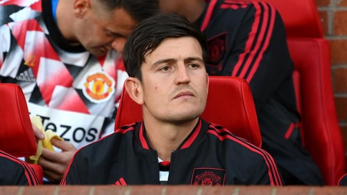 MANCHESTER, ENGLAND - AUGUST 22: Harry Maguire of Manchester United looks on from the substitutes bench prior to the Premier League match between Manchester United and Liverpool FC at Old Trafford on August 22, 2022 in Manchester, England. (Photo by Michael Regan/Getty Images)