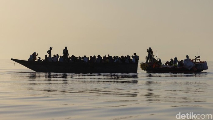 Migrants, left, are being rescued by volunteers of the Ocean Viking, a migrant search and rescue ship run by NGOs SOS Mediterranee and the International Federation of Red Cross (IFCR),  Saturday, Aug. 27, 2022, some 26 nautical miles south of the Italian Lampedusa island in the Mediterranean sea. 87 survivors, including 3 women, 25 minors were rescued in the rescue operation. (AP Photo/Jeremias Gonzalez)