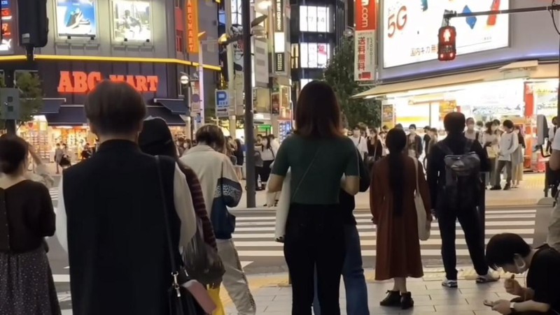 Rekaman video memperlihatkan keadaan jalan umum yang dipenuhi oleh para pekerja baru pulang. Ada seorang wanita di seberang jalan sedang meluapkan kestresannya.