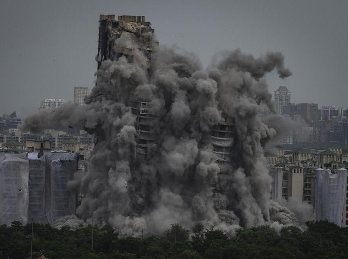 Cloud of dust rises as twin high-rise apartment towers are razed to ground in Noida, outskirts of New Delhi, India, Sunday, Aug. 28, 2022. The demolition was done after the countrys top court declared them illegal for violating building norms. The 32-story and 29-story towers, constructed by a private builder were yet to be occupied and became Indias tallest structures to be razed to the ground. (AP Photo/Altaf Qadri)