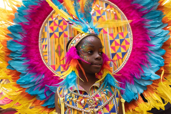 LONDON, ENGLAND - AUGUST 28: Revellers process down the route during the Notting Hill carnival on August 28, 2022 in London, England. The Caribbean carnival returns to the streets of Notting Hill after a two-year hiatus due to the Covid pandemic. (Photo by Dan Kitwood/Getty Images)