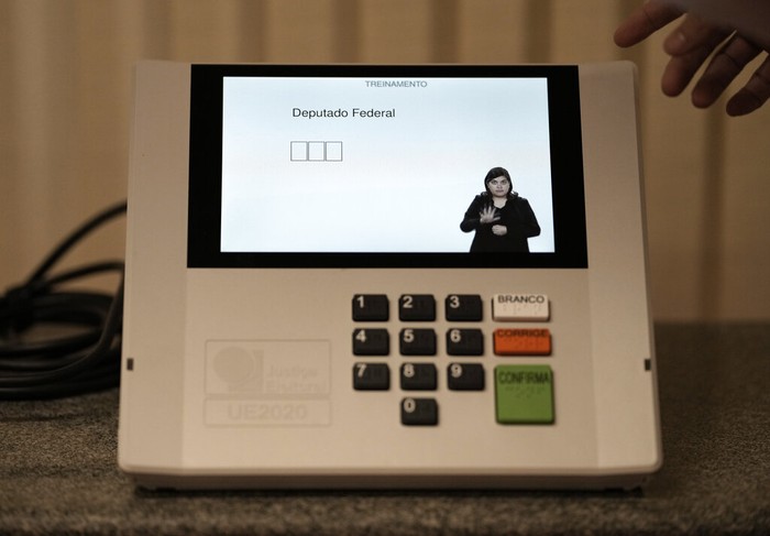 Brazil Elections A worker at the Regional Electoral Court shows an electronic voting machine in Rio de Janeiro, Brazil, Monday, Aug. 29, 2022. General elections are set for Oct. 2. (AP Photo/Silvia Izquierdo)