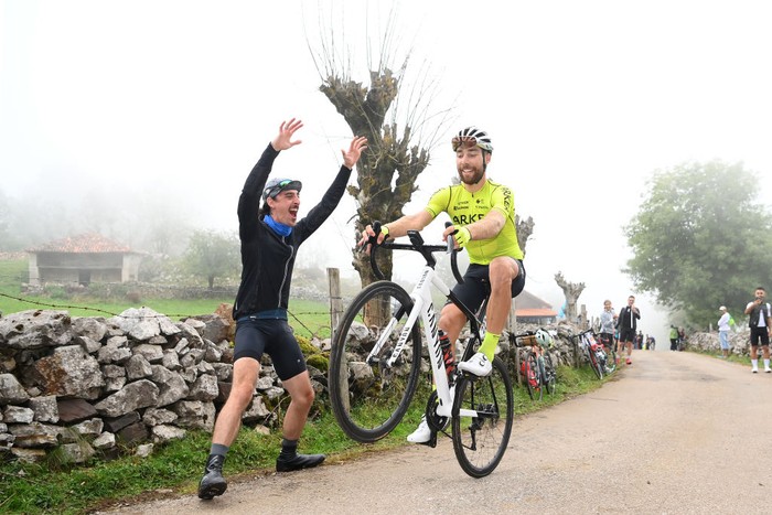 1418517278 COLLÁU FANCUAYA, SPAIN - AUGUST 27: Clement Russo of France and Team Arkéa - Samsic makes wheelie while fans cheer during the 77th Tour of Spain 2022, Stage 8 a 153,4km stage from Pola de Laviana to Colláu Fancuaya 1084m / #LaVuelta22 / #WorldTour / on August 27, 2022 in Colláu Fancuaya, Spain. (Photo by Justin Setterfield/Getty Images)
