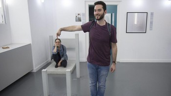 Seorang pria dan wanita berpose di Museum of Illusion di Wina, Austria, pada 16 Oktober 2017. Pria tersebut terlihat lebih besar secara ukuran dari wanitanya.