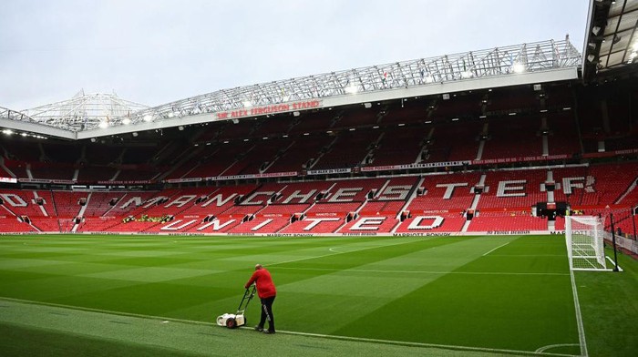 A groundsman paints the lines as final preparations are done ahead of the English Premier League football match between Manchester United and Liverpool at Old Trafford in Manchester, north west England, on August 22, 2022. - RESTRICTED TO EDITORIAL USE. No use with unauthorized audio, video, data, fixture lists, club/league logos or live services. Online in-match use limited to 120 images. An additional 40 images may be used in extra time. No video emulation. Social media in-match use limited to 120 images. An additional 40 images may be used in extra time. No use in betting publications, games or single club/league/player publications. (Photo by Paul ELLIS / AFP) / RESTRICTED TO EDITORIAL USE. No use with unauthorized audio, video, data, fixture lists, club/league logos or live services. Online in-match use limited to 120 images. An additional 40 images may be used in extra time. No video emulation. Social media in-match use limited to 120 images. An additional 40 images may be used in extra time. No use in betting publications, games or single club/league/player publications. / RESTRICTED TO EDITORIAL USE. No use with unauthorized audio, video, data, fixture lists, club/league logos or live services. Online in-match use limited to 120 images. An additional 40 images may be used in extra time. No video emulation. Social media in-match use limited to 120 images. An additional 40 images may be used in extra time. No use in betting publications, games or single club/league/player publications. (Photo by PAUL ELLIS/AFP via Getty Images)
