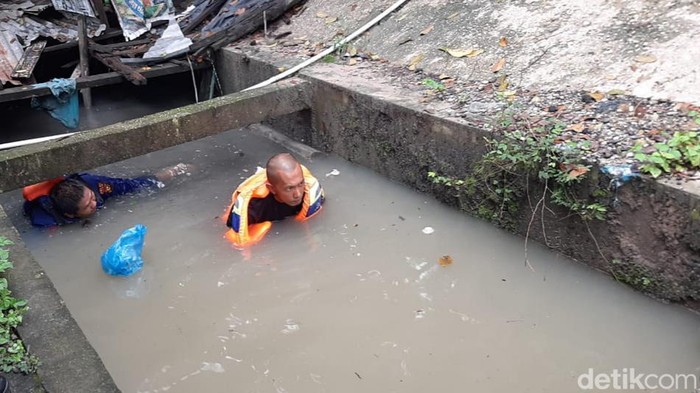 Proses pencarian anak hilang terseret air di parit.
