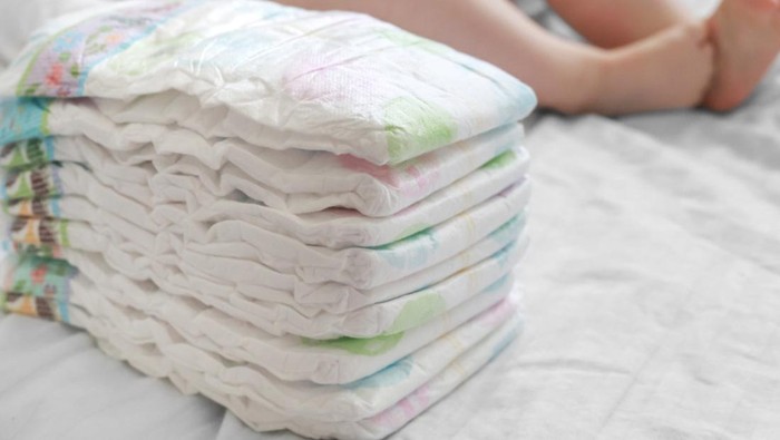 Stack of diapers on a white bed