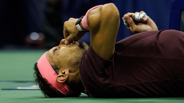 NEW YORK, NEW YORK - SEPTEMBER 01: Rafael Nadal of Spain lies down to receive medical treatment on his nose after hitting himself with his own racket during his match against Fabio Fognini of Italy in the second round of the men's singles at the US Open at the USTA Billie Jean King National Tennis Center on September 01, 2022 in New York City. (Photo by Frey/TPN/Getty Images)