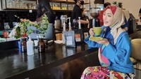 Penuh warna! Begini momen Angelina Sondakh ngopi di kafe kekinian. Ia pesan kopi dengan gula aren yang legit manis.