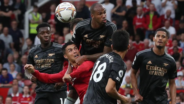 MANCHESTER, ENGLAND - SEPTEMBER 04: Cristiano Ronaldo of Manchester United in action with William Saliba of Arsenal during the Premier League match between Manchester United and Arsenal FC at Old Trafford on September 04, 2022 in Manchester, England. (Photo by Tom Purslow/Manchester United via Getty Images)