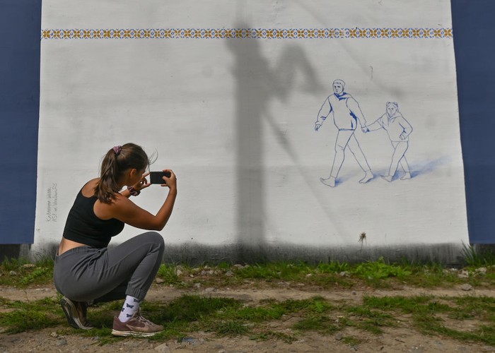 1242971324 A cyclist passes by a pro-Ukrainian mural entitled 'No More Time' created by Polish artist TUSE (Piotr TUSE Jaworski).
More than 25 anti-war and pro-Ukrainian murals were painted on the wall at the Gdask Jasie train station as part of the project 'In solidarity with Ukraine' initiated by the PKM (Pomeranian Metropolitan Railway) and the Gdask Academy of Fine Arts. Most of the authors are students of the Academy of Fine Arts.
Last weekend, another 10 new murals were created, all related to the Russia-Ukraine conflict in 2022.
On Monday, September 05, 2022, in Gdansk, Pomeranian Voivodeship, Poland. (Photo by Artur Widak/NurPhoto via Getty Images)