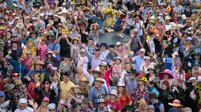 BRIDPORT, ENGLAND - SEPTEMBER 03: Participants gather for the traditional group hat photo at Bridport Hat Festival, on September 03, 2022 in Bridport, England. Bridport's quirky Hat Festival features hundreds of participants dressed in elegant, creative, technically ingenious and often bizarre creations. Along with various 'Best Hatted' competitions, there is 'Hat Hurling' and 'Best Hatted Dog' raising money for head-related charities. (Photo by Finnbarr Webster/Getty Images)