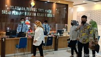 Atut datang mengenakan pakaian putih dengan setelan kerudung motif kuning dan cokelat. Ia langsung menuju meja pelayanan Bapas.