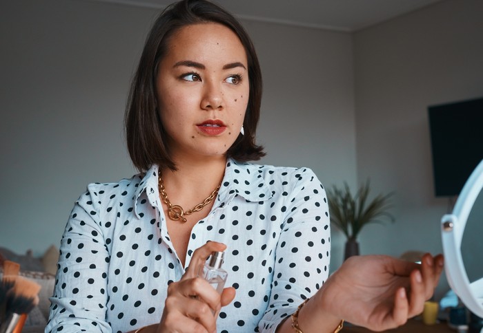 beautiful asian woman in white bathing dress enjoy good smell of new perfume bathroom background