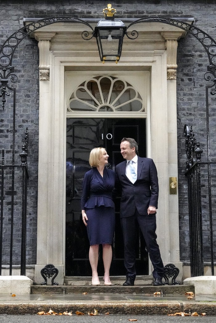 New British Prime Minister Liz Truss and her husband Hugh O'Leary pose outside Downing Street in London, Tuesday, Sept. 6, 2022, after returning from Balmoral in Scotland where she was formally appointed by Britain's Queen Elizabeth II. (AP Photo/Frank Augstein)