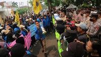 Seorang mahasiswa dari Pergerakan Mahasiswa Islam Indonesia (PMII) yang sedang berbicara di antara mahasiswa lainnya dan sejumlah polisi di depan gedung DPRD Kabupaten Jombang, Jawa Timur, Selasa (6/9/2022). (Syaiful Arif/Antara Foto)