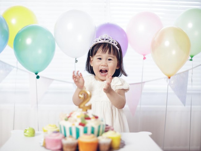 Two years old baby girl celebrating her second  birthday at home