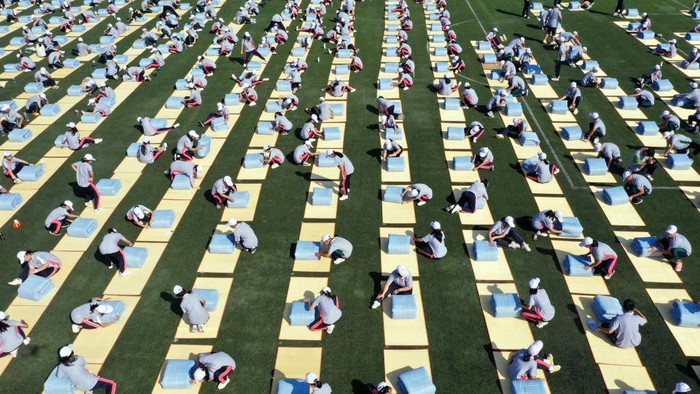 DONGYANG, CHINA - SEPTEMBER 06: Aerial view of freshmen competing in a quilt folding contest during a military training at Dongyang vocational education center school on September 6, 2022 in Dongyang, Jinhua City, Zhejiang Province of China. (Photo by VCG/VCG via Getty Images)