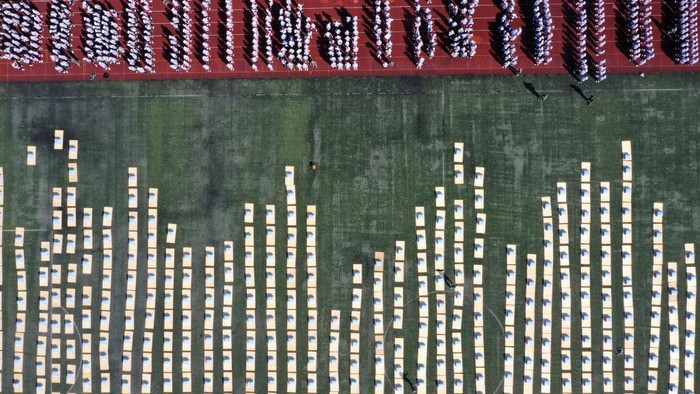 DONGYANG, CHINA - SEPTEMBER 06: Aerial view of freshmen competing in a quilt folding contest during a military training at Dongyang vocational education center school on September 6, 2022 in Dongyang, Jinhua City, Zhejiang Province of China. (Photo by VCG/VCG via Getty Images)