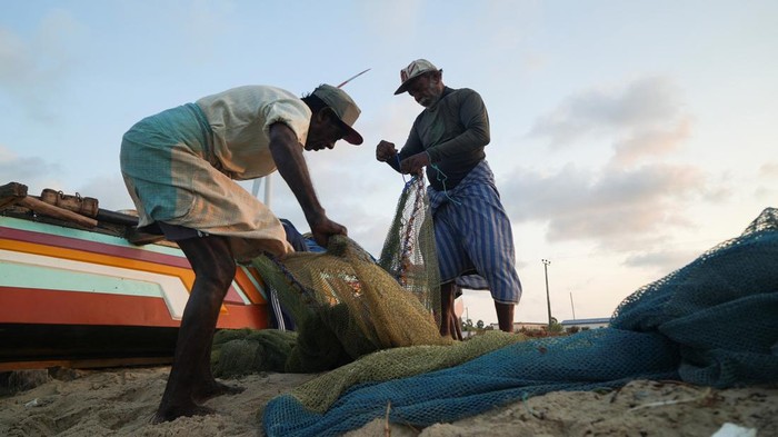A group of local fishermen head out to sea in their boat just off the shore of Mannar, Sri Lanka, August 17, 2022. REUTERS/Joseph Campbell