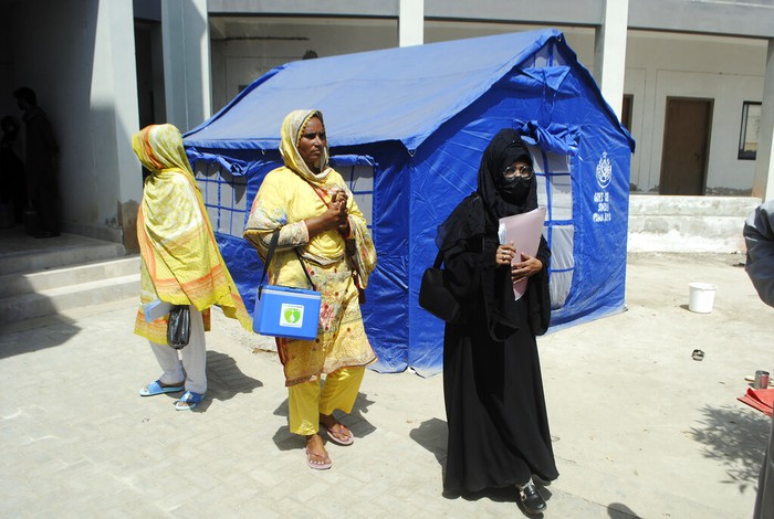 Pakistan Floods Health workers go door to door dispensing vaccinations for flood victims from monsoon rains at a camp in Hyderabad, Pakistan, Tuesday, Sept. 6, 2022. In flood-stricken Pakistan where an unprecedented monsoon season has already killed hundreds of people, the rains are now threatening an ancient archeological site dating back 4,500 years, the site's chief official said Tuesday. (AP Photo/Pervez Masih)
