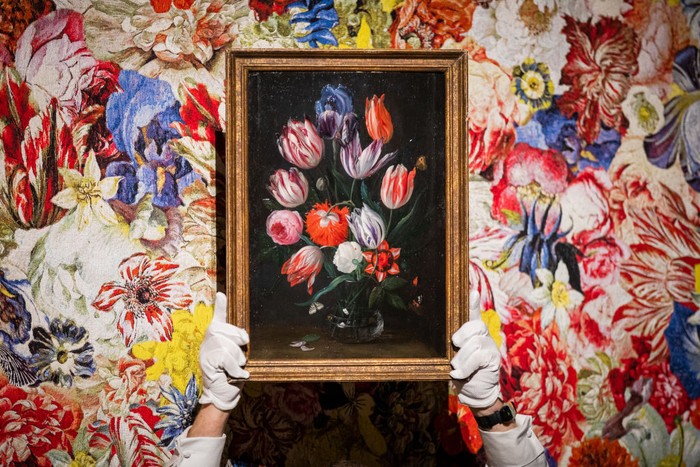 LONDON, ENGLAND - SEPTEMBER 07: A still life of flowers in a glass vase by Jan van Kessel (estimate £120,000 - £180,000) from The Grasset Collection, one of the greatest private collections of 17th-century still life paintings ever assembled, is unveiled in front of Dutch Golden Age Tapestry by Rob and Nick Carter at Sotheby’s on September 07, 2022 in London, England. On public exhibition in Europe for the first time, the collection is being presented in dialogue with works by acclaimed artists Rob and Nick Carter, and with floral installations by SAGE Flowers. Property from The Grasset Collection will be offered in Sotheby’s London Old Masters Evening Sale on December 7, 2022. (Photo by Tristan Fewings/Getty Images for Sotheby's)