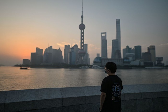 A man practices shadow boxing on the Bund promenade along the Huangpu River during sunrise in Shanghai on September 7, 2022. (Photo by HECTOR RETAMAL / AFP) (Photo by HECTOR RETAMAL/AFP via Getty Images)