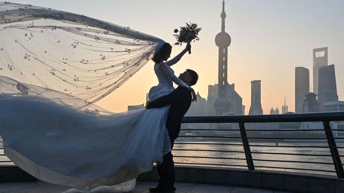 Menikmati Indahnya Matahari Terbit di Sungai Huangpu, Shanghai A man practices shadow boxing on the Bund promenade along the Huangpu River during sunrise in Shanghai on September 7, 2022. (Photo by HECTOR RETAMAL / AFP) (Photo by HECTOR RETAMAL/AFP via Getty Images)