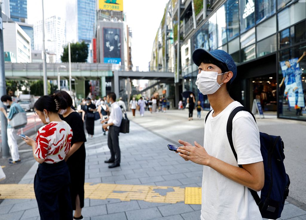 Shoji Morimoto who charges 10,000 yen ($71.30) per booking to accompany clients and simply exist as a companion, poses at Shibuya crossing in Tokyo, Japan August 31, 2022. REUTERS/Kim Kyung-Hoon REFILE - CORRECTING RATE