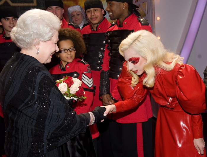 Britain's Queen Elizabeth II (L) meets American singer Lady Gaga (R) following the Royal Variety Performance in Blackpool, England on December 7, 2009. Returning to the town for the first time since 1955, the annual show features a wide range of artists from all aspects of popular entertainment and showbusiness. AFP PHOTO/Leon Neal/POOL (Photo credit should read LEON NEAL/AFP via Getty Images)