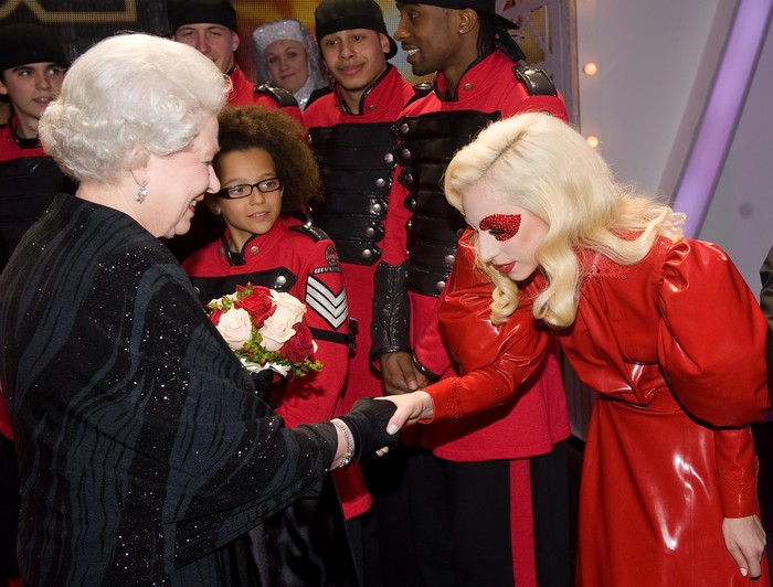 111654739 Britain's Queen Elizabeth II (L) meets American singer Lady Gaga (R) following the Royal Variety Performance in Blackpool, England on December 7, 2009. Returning to the town for the first time since 1955, the annual show features a wide range of artists from all aspects of popular entertainment and showbusiness. AFP PHOTO/Leon Neal/POOL (Photo credit should read LEON NEAL/AFP via Getty Images)