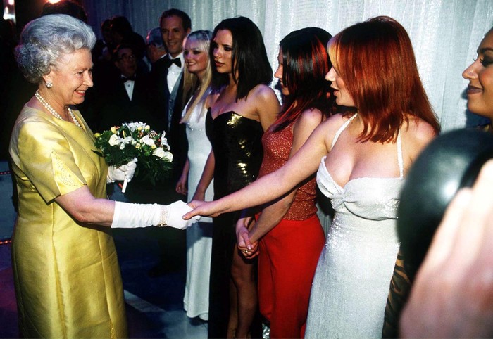 LONDON, UNITED KINGDOM - DECEMBER 01:  The Queen At The Royal Command Performance At The Victoria Palace Theatre On 1st December 1997 Shaking Hands With Pop Star Geri Halliwell (ginger Spice) From The Pop Band The Spice Girls  (Photo by Tim Graham Picture Library/Getty Images)