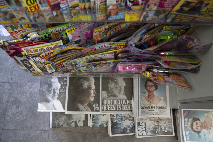 Newspapers devoted to the death of Queen Elizabeth II are seen in Manchester, England, Friday, Sept. 9, 2022. Queen Elizabeth II, Britain's longest-reigning monarch, died on Thursday Sept. 8 aged 96. (AP Photo/Jon Super)