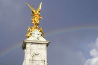 People gather outside Buckingham Palace in London as a double rainbow appears in the sky, Thursday, Sept. 8, 2022. Buckingham Palace says Queen Elizabeth II has been placed under medical supervision because doctors are 