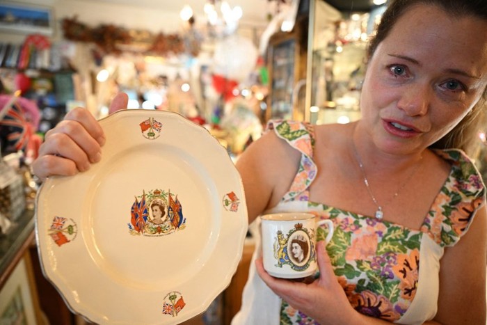 Gambar Ratu Elizabeth II di Rose Tree Cottage English Tea Room Local resident Brecken Armstrong displays commemorative items she is purchasing to remember Queen Elizabeth II during a visit to the Rose Tree Cottage English Tea Room in Pasadena, California following the death today of Queen Elizabeth II on September 8, 2022. Armstrong and her husband Martin said they admired the Queen's strong and positive feminine role. Martin said