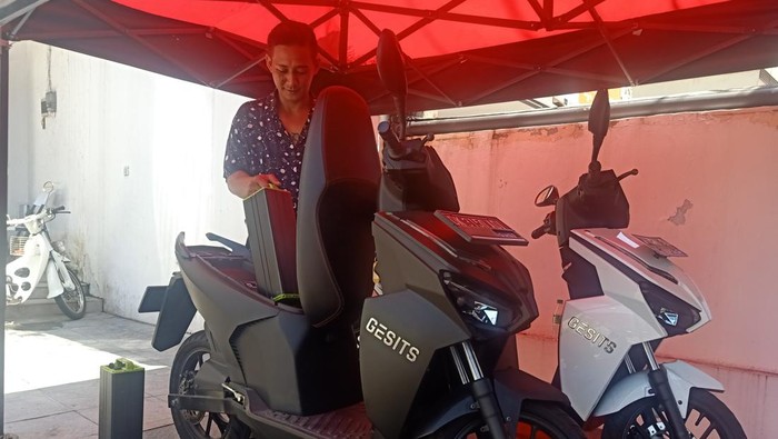 Manager Area GESITS Bali Pratama, Reza Hidayat menunjukkan proses penggantian baterai pada motor listrik G1 di GESITS Bali Pratama, Denpasar Barat, Bali, Jumat (9/9/2022).