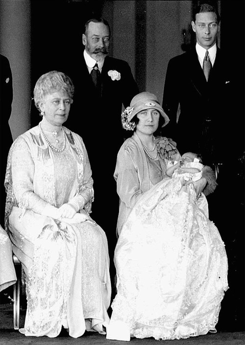 Britains Duchess of York, right, holds her baby daughter, Princess Elizabeth, on her christening day in 1926.  Seated at left is Queen Mary, with King George V standing behind, and the Duke of York at right.  (AP Photo)