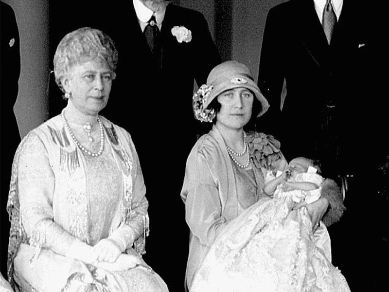 Britain's Duchess of York, right, holds her baby daughter, Princess Elizabeth, on her christening day in 1926.  Seated at left is Queen Mary, with King George V standing behind, and the Duke of York at right.  (AP Photo)