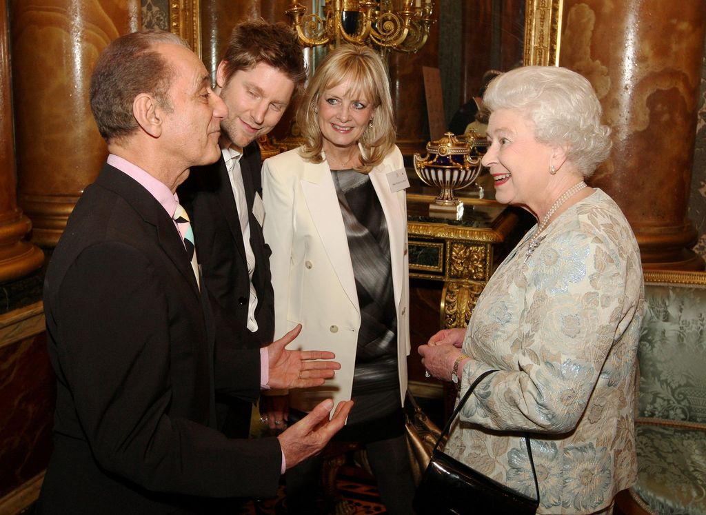 Queen Elizabeth II speaks to (left to right) David Sassoon, Christopher Bailey from Burberry, and model Twiggy at a reception for the British Clothing Industry, including an exhibition of contemporary clothing curated by the Victoria and Albert Museum, at Buckingham Palace, London.   (Photo by Dominic Lipinski/PA Images via Getty Images)