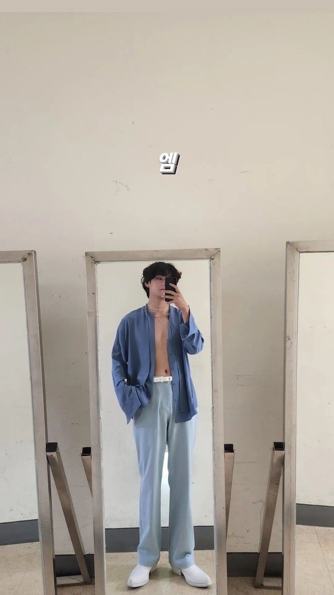 Foto seksi yang dibagikan V BTS pada 16 Juni 2022 tak kalah menggemparkan. Saat sedang berada di ruang ganti acara musik M Countdown, V BTS mengambil mirror selfie meskipun bajunya belum diresleting. Foto: Instagram